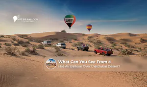 Hot air balloon flying over the Dubai desert at sunrise.