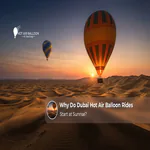 Hot air balloons rising over the Dubai desert during the early morning sunrise.